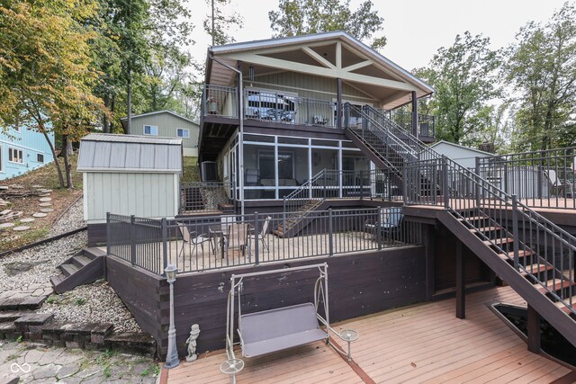 7438 Haw Dr, Nineveh, IN 46164 - back of house featuring a sunroom, a wooden deck, and stairway