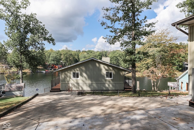 7438 Haw Dr, Nineveh, IN 46164 - exterior space featuring a chimney, concrete driveway, and a water view