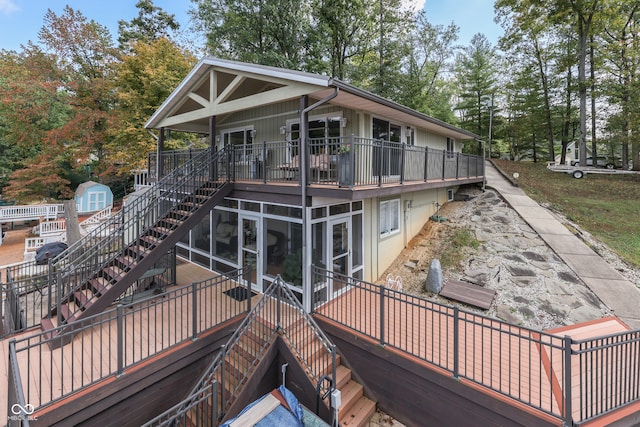 7438 Haw Dr, Nineveh, IN 46164 - back of house with stairs, a deck, and a sunroom