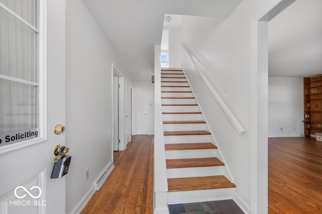 stairway with hardwood / wood-style flooring