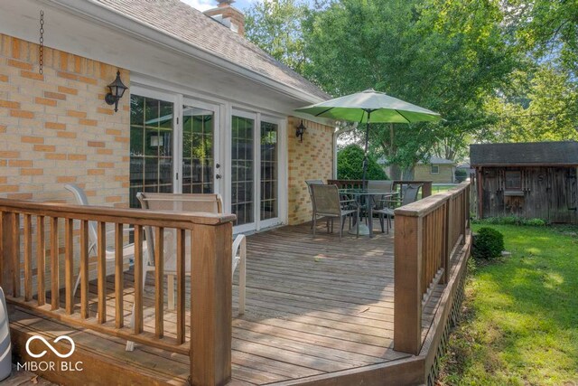 wooden deck featuring a lawn