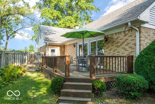 wooden terrace featuring a yard