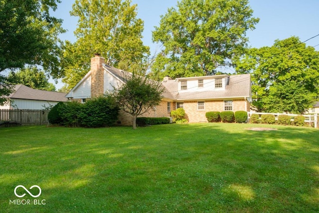 rear view of house with a lawn