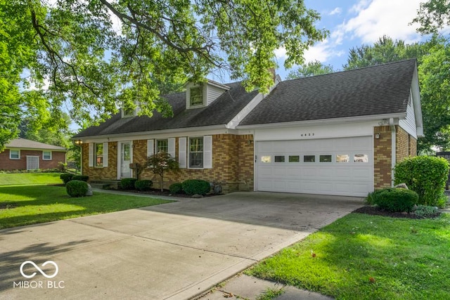 view of front of property with a front yard and a garage