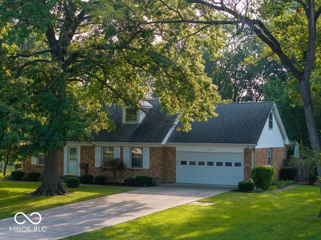 view of front of home with a front yard and a garage