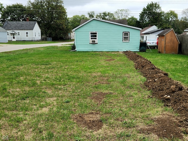 view of yard featuring fence and an outdoor structure