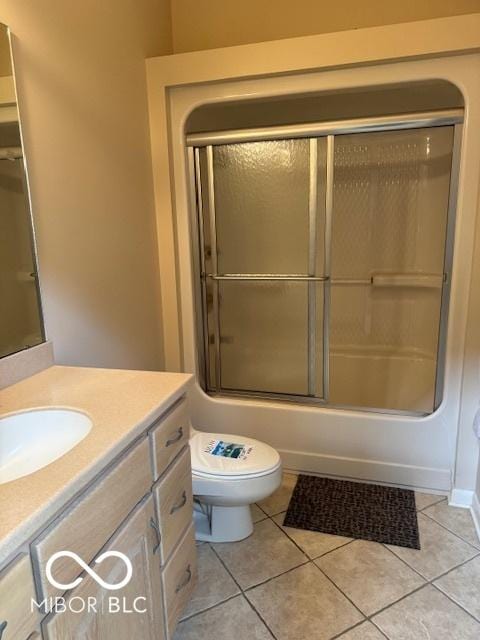 full bath featuring tile patterned flooring, vanity, toilet, and enclosed tub / shower combo