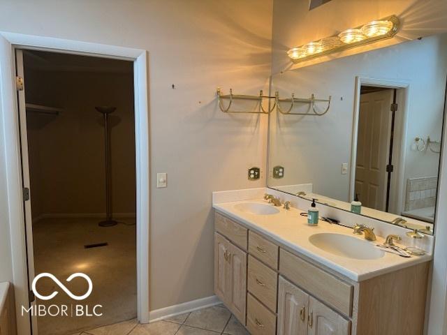 full bathroom featuring double vanity, tile patterned floors, and baseboards