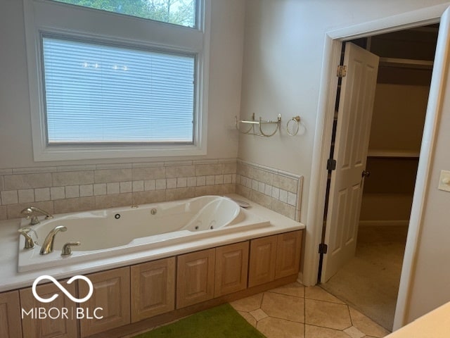 bathroom with a bathtub and tile patterned flooring