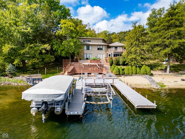 dock area featuring a water view, boat lift, and stairway