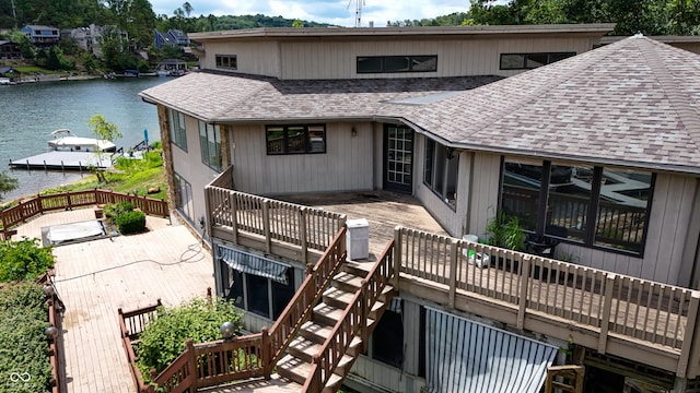 4161 S Summit Ln, Columbus, IN 47201 - rear view of house featuring a shingled roof, a deck with water view, and a sunroom