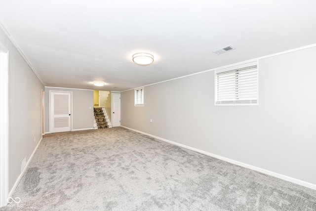 basement featuring light carpet and crown molding