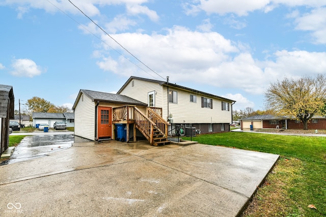 rear view of property featuring a lawn