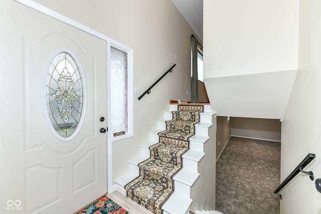 view of carpeted foyer entrance