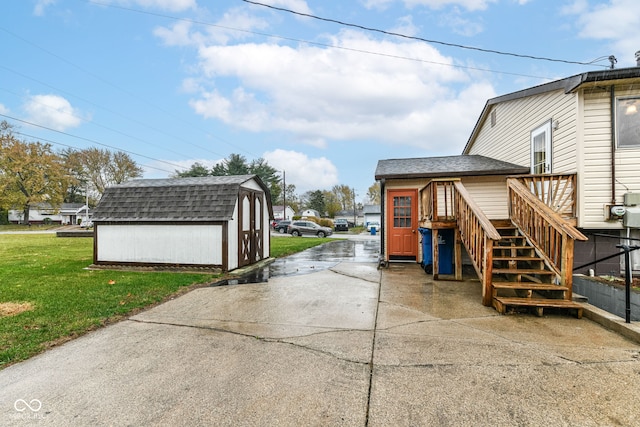 exterior space with a storage unit and a yard