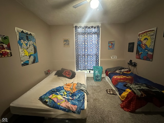 bedroom featuring carpet, ceiling fan, and a textured ceiling