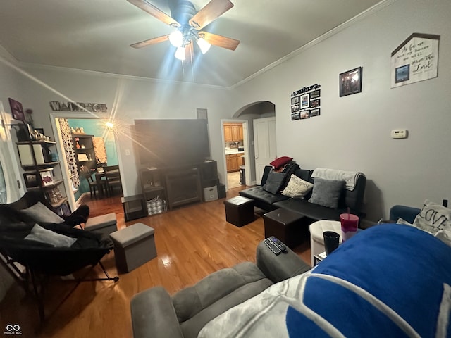 living room featuring ceiling fan, hardwood / wood-style flooring, and crown molding