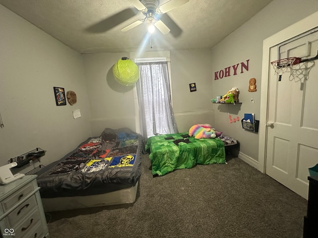 carpeted bedroom featuring a textured ceiling and ceiling fan