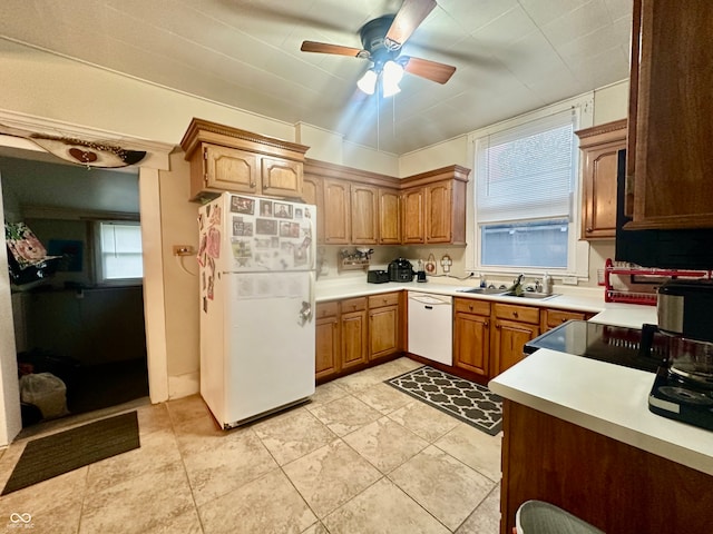 kitchen with ceiling fan, sink, white appliances, and a healthy amount of sunlight