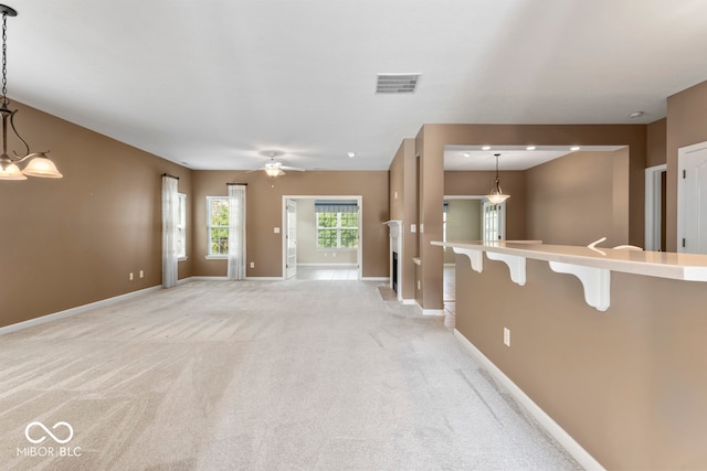 carpeted spare room with ceiling fan