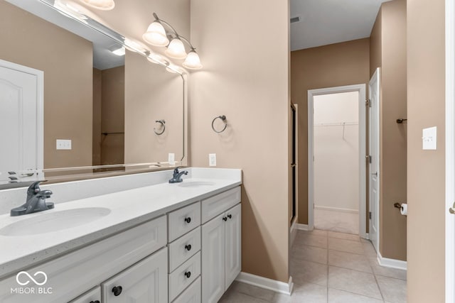 bathroom featuring vanity, an enclosed shower, and tile patterned flooring