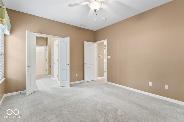 unfurnished bedroom with ceiling fan and light carpet