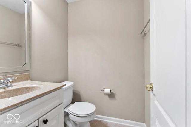 bathroom with tile patterned flooring, vanity, and toilet