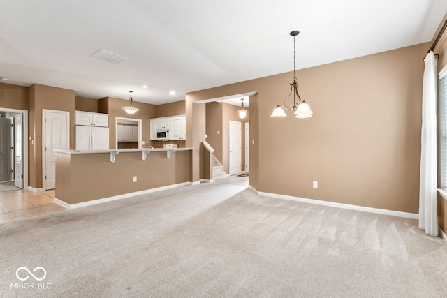 unfurnished living room featuring light colored carpet