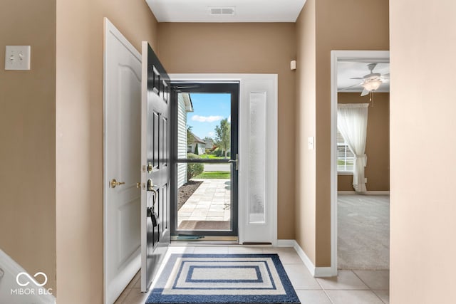 tiled foyer with a healthy amount of sunlight