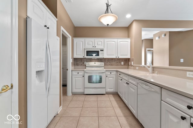 kitchen featuring pendant lighting, tasteful backsplash, white cabinets, light tile patterned floors, and white appliances