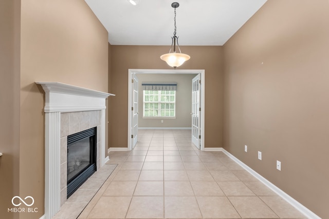 unfurnished living room featuring light tile patterned flooring and a tiled fireplace