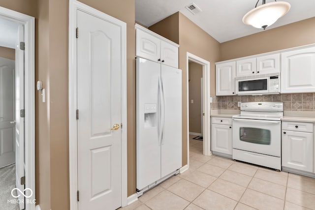 kitchen featuring backsplash, white cabinets, white appliances, and decorative light fixtures