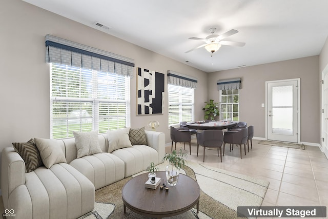 living room with ceiling fan and light tile patterned floors