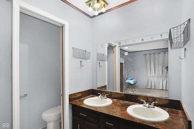 bathroom featuring ornamental molding, toilet, and vanity