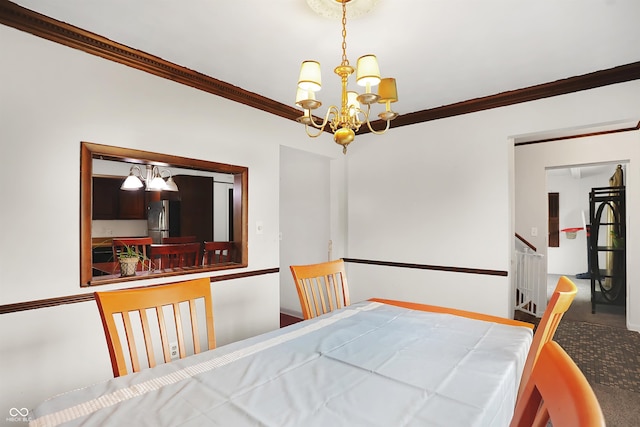 carpeted dining space with crown molding and an inviting chandelier