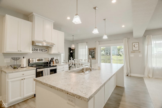 kitchen with a kitchen island with sink, sink, white cabinetry, stainless steel electric range oven, and hanging light fixtures