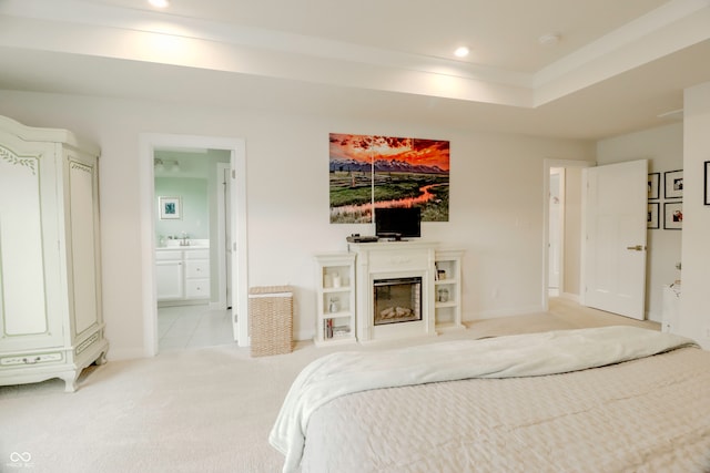 carpeted bedroom featuring ensuite bath