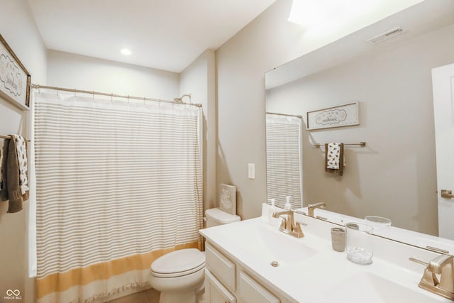 full bathroom with tile patterned floors, shower / bath combo, vanity, and toilet