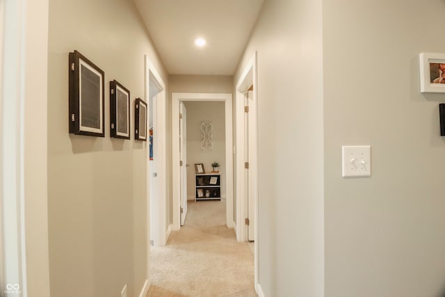 hallway with light colored carpet