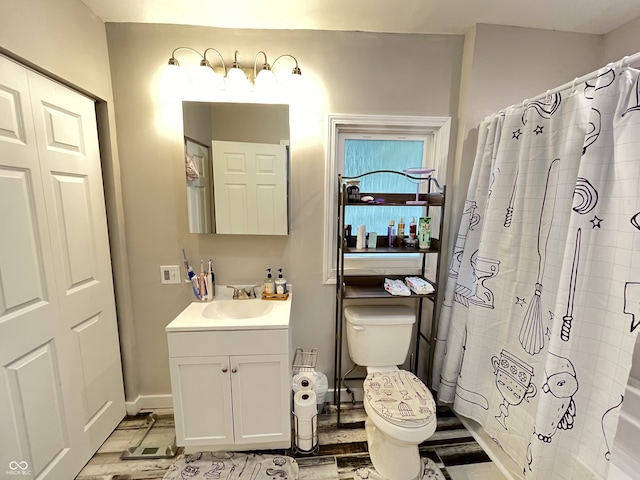 bathroom featuring a shower with curtain, hardwood / wood-style flooring, vanity, and toilet