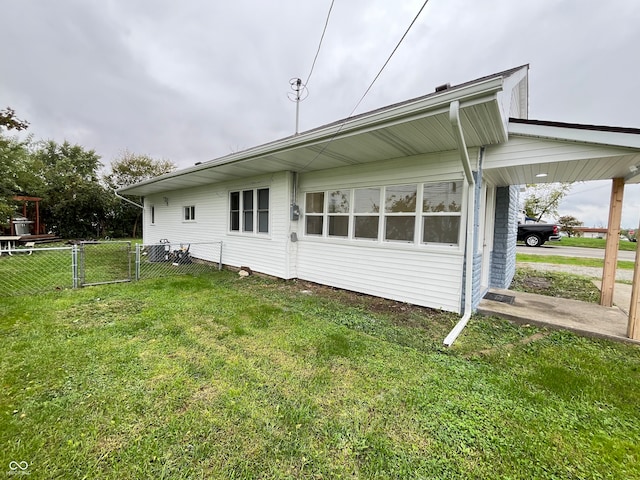 view of property exterior featuring a lawn and a carport