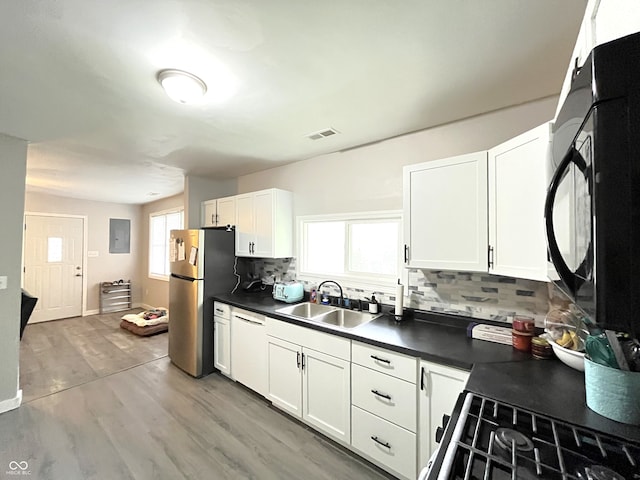 kitchen featuring white cabinets, sink, tasteful backsplash, dishwasher, and hardwood / wood-style floors