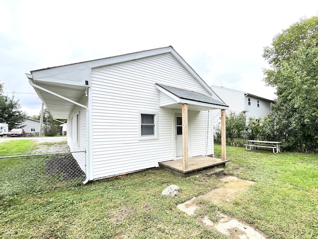 back of property featuring a yard