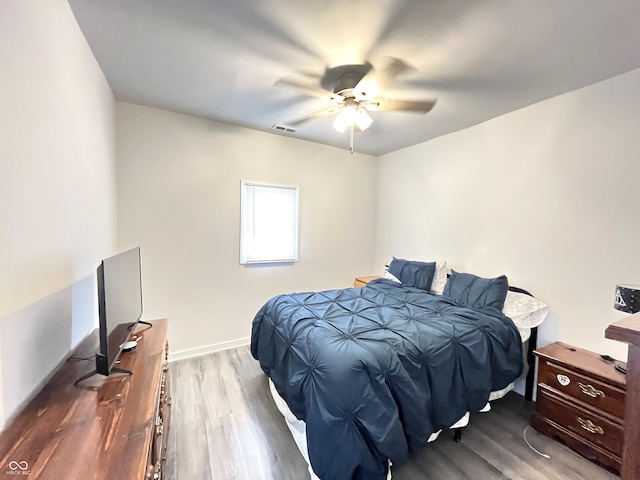 bedroom with hardwood / wood-style floors and ceiling fan