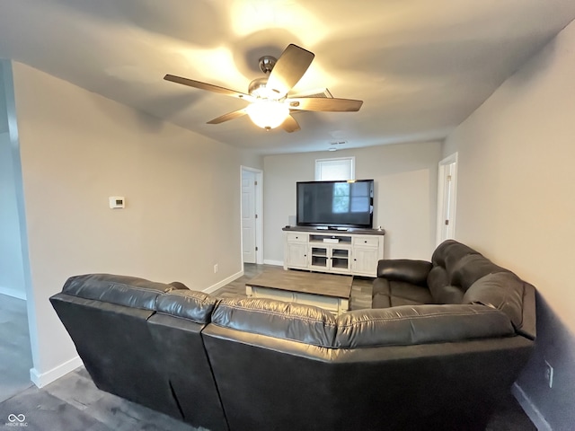 living room with ceiling fan and carpet flooring