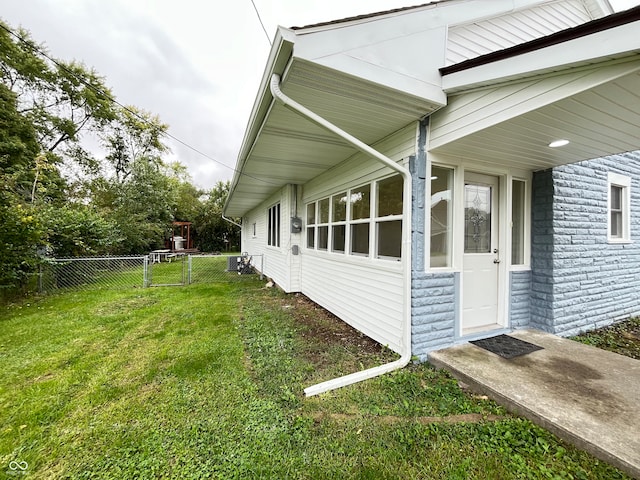 view of side of property with a lawn