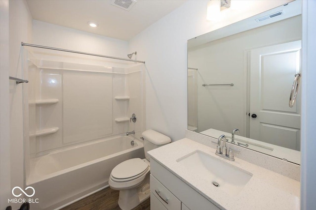 full bathroom featuring hardwood / wood-style flooring, vanity,  shower combination, and toilet