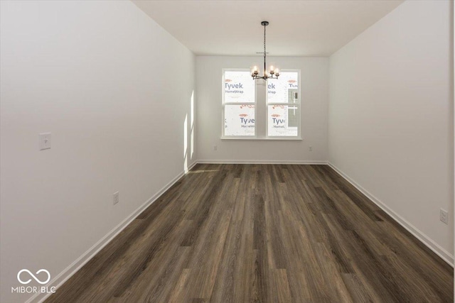 unfurnished dining area featuring dark hardwood / wood-style flooring and a notable chandelier