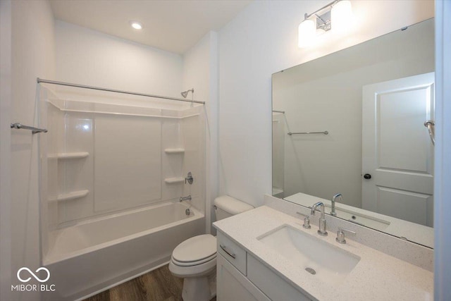 full bathroom featuring vanity, wood-type flooring, shower / bathtub combination, and toilet