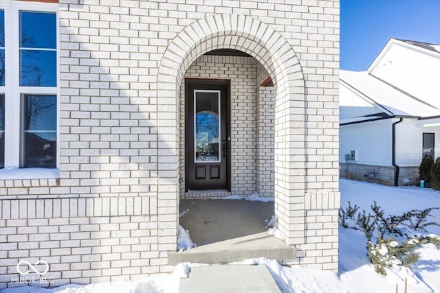 view of snow covered property entrance